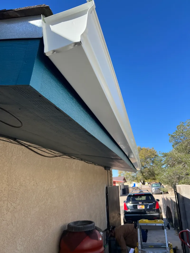 Professional seamless gutter installation on a Texas home